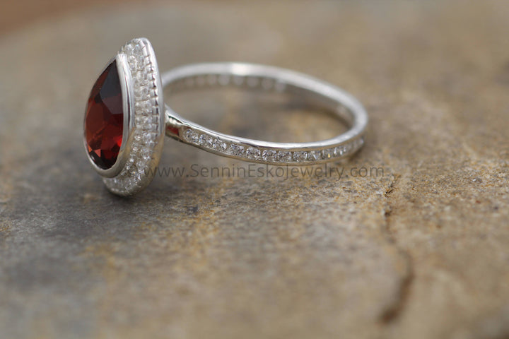 Diamond Halo Ring with Channel Set Band - Depcited with a Pear Cut Garnet (Setting Only, Center Stone Sold Separately) Sennin Esko Jewelry Alternative Engagem, Diamond Engagement, Diamond Garnet Ring, Engagement Ring, Garnet, Garnet Bezel  Loose Settings